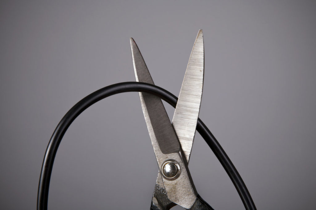 Scissors cutting a cord