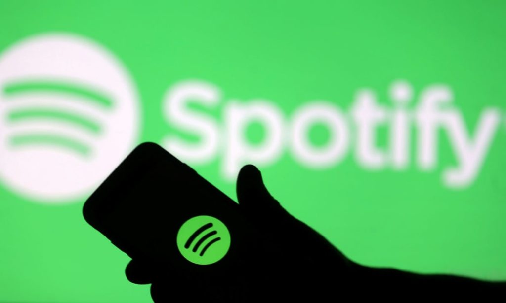 Person holding phone with spotify logo